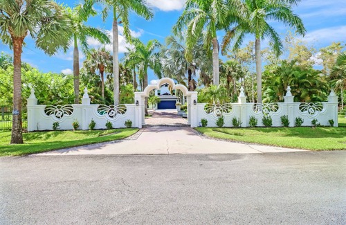 Rural Estates House | Stunning Naples home on 2 acres surrounded by beautiful palm trees and pool!