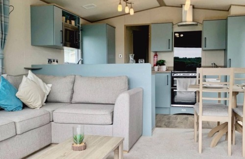 Heacham Ski Chalet | Stunning river view 2 bedroom caravan with decking