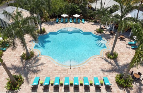 New Town Hotel | Sun, Sip, & Socialize | Island Stay with 2 Pools & Lawn Games
