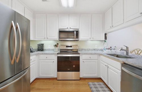 Demere Park Condo | Sunny Pool, 1 mile to the Beach, new TVs, 5 Balconies, and Private Elevator!