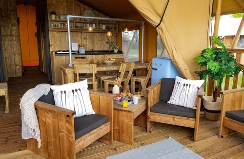 Bant House | Tents with kitchen and bathroom near a pond