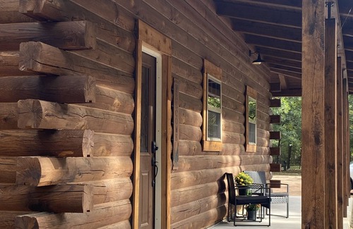 Tishomingo Cabin | The Cozy Pines is a newly built, romantic log cabin with a 2-sided fireplace.