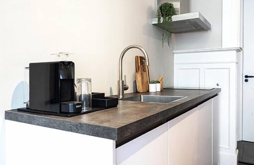 Centrum Apartment | The ground floor studio, spanning 30m2, offers a cozy retreat with a stylish wood herringbone floor