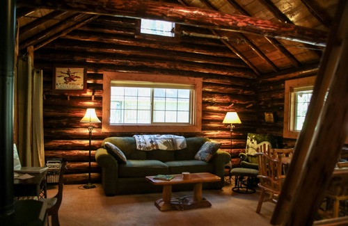 Seeley Lake Cabin | The Saddle Shed at Tamaracks Resort is a log cabin with furnished screen porch.
