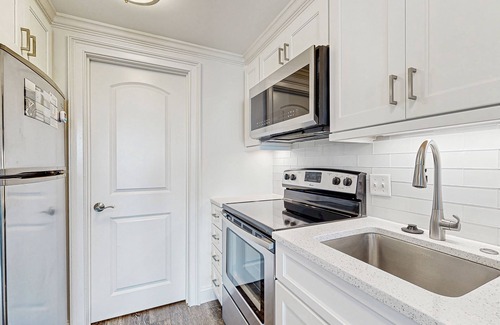 West Beach Village Villa | Third floor home with stunning private-deck ocean views - steps from beach