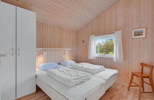 Østerskov House | This beautiful wooden house is located in a smaller cottage area, nestled in beautiful nature.