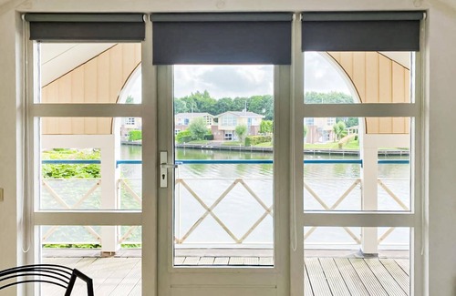 Workum House | This luxury waterfront vacation home is located in a cottage area and close to a boat rental.