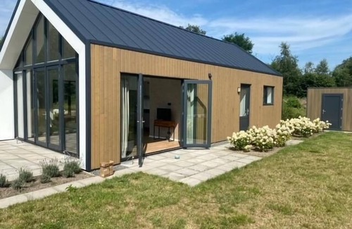 Gasselte House | This modern vacation home is the place to be. The house is suitable for four people, has two bedrooms and is completely on one level. Around the house is a spacious garden to relax in the sun.
