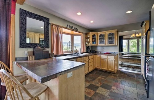Tamarack Resort Apartment | This private riverfront escape near McCall sleeps 22+! Bar/game room, huge kitchen/dining. Between Tamarack & Brundage, with ride-out snowmobile trail access. Cozy fireplace & big TVs for sports fans.