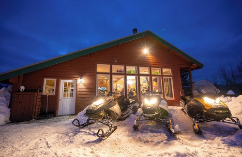 Tamarack Resort Apartment | This private riverfront escape near McCall sleeps 22+! Bar/game room, huge kitchen/dining. Between Tamarack & Brundage, with ride-out snowmobile trail access. Cozy fireplace & big TVs for sports fans.