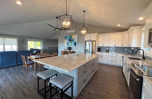 Mid-Coast and Islands House | This spacious home offers a FANTASTIC covered porch, perfect to spend your days gazing at the ocean!
