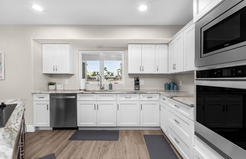 Saint James City House | THREE MASTER SUITES-POOL -WATERFRONT ON CORNER LOT - BOAT LIFT -OUTDOOR KITCHEN