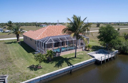 Burnt Store House | Tommy Bahama-style electric-heated pool home on Gulf-access canal - Villa Ellis