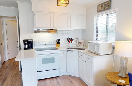 Tybee Island Condo | Top floor condo w. partial ocean + community pool views.