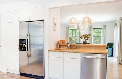 Sag Harbor House | Traditional-style home with pops of patterns and vibrant colors, private.