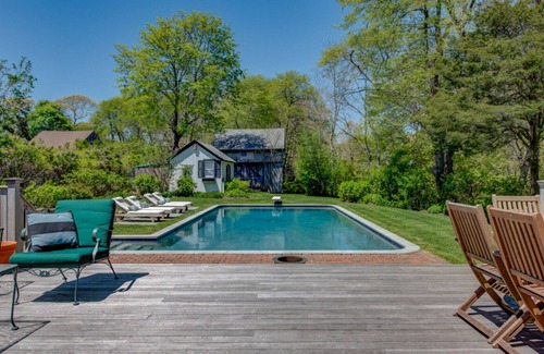 Quogue House | Traditional-style home with private pool, several sitting rooms, back deck,...