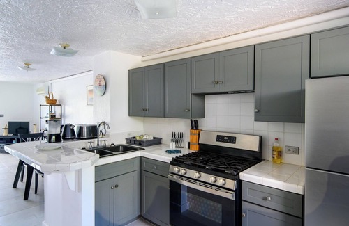Jolly Harbour Villa | Tranquil Waterfront Villa ~ steps from the Beach, with bikes and terrace views