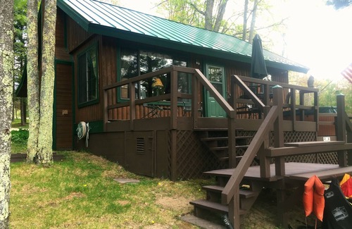 South Boardman Cottage | Traverse City area Lakefront Log Home, FREE Hot Tub, WIFI, & Boats.