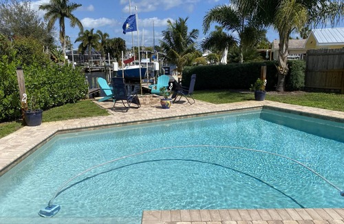 Palm City Cottage | Tropical Getaway! Waterfront Bungalow with Heated Pool, Firepit, & Kayaks