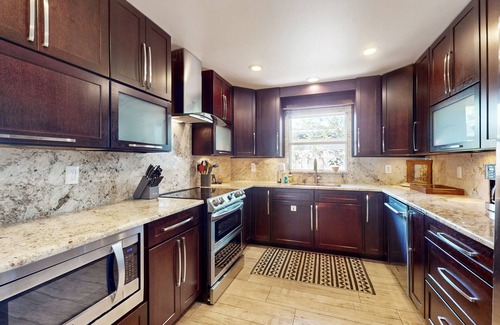 Cocoa Isles House | Tropical home with pool, lovely patio & game room - walk to beach