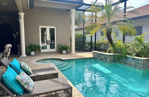 Longshore Lake House | Tropical Retreat - pet friendly 3 bedroom 3 bath home with pool and hot tub.