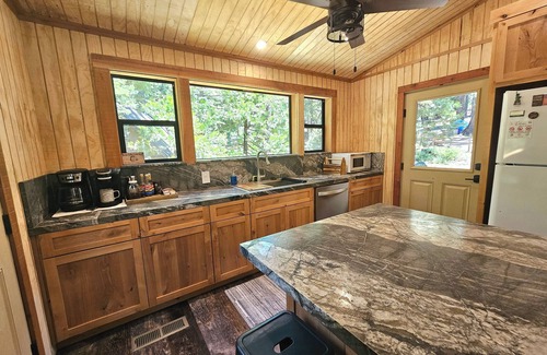 Sierra Cedars Cabin | Tucked in the trees, Cedar Hill is a cozy A-frame cabin with modern updates, a spacious kitchen, wraparound deck, and stunning views. The perfect mountain escape for families, couples, and friends—plus, it's pet-friendly!