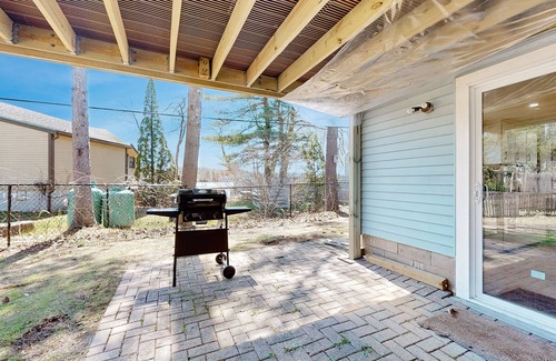 Sandown House | Two-story dog-friendly home with a lake view, deck, gas grill