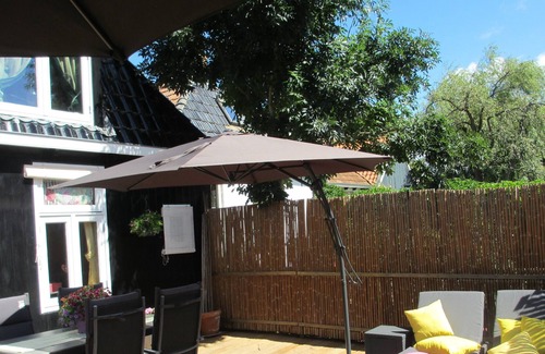 Molkwerum House | Unique holiday apartment with its own pretty terrace on the water.