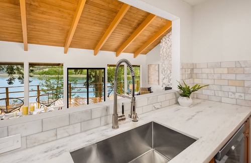 Rollingbay House | Updated beachfront home with private beach, water views, spacious deck, & W/D