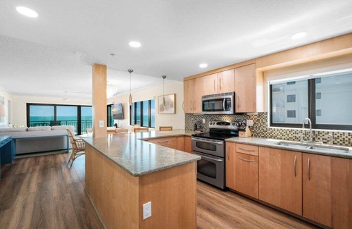 New Smyrna Beach Condo | Updated direct oceanfront corner condo with large wrap-around balcony and heated pool