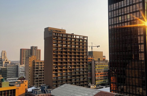 Downtown Johannesburg Apartment | Urban energy meets secure comfort in a historic landmark.
