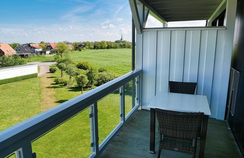 Wremen Apartment | Vacation apartment near the beach with sauna & beautiful, covered balcony with dyke view