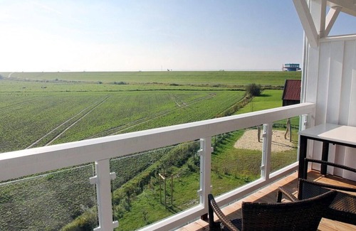 Wremen Apartment | Vacation apartment near the beach with sauna, balcony with beach chair and wonderful view
