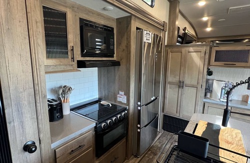 Lakeside House | Vacation Camper with private area behind with Seating, Firepit, and Hot tub