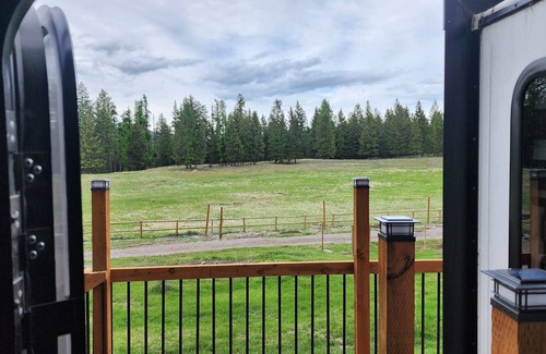Lakeside House | Vacation Camper with private area behind with Seating, Firepit, and Hot tub