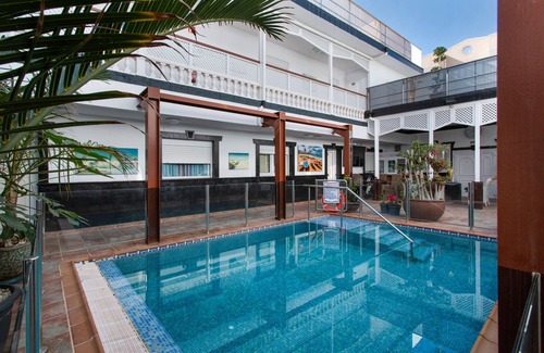 Playa de Arinaga Apartment | Vacation 'Casa Paula - 22' with Mountain View, Shared Pool and Wi-Fi