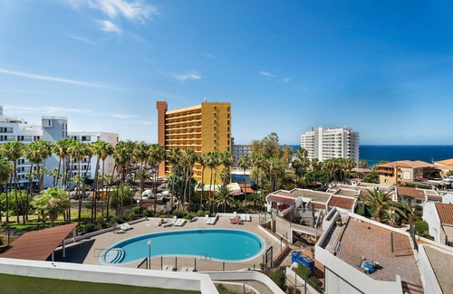 San Eugenio Apartment | Vacation Studio 'Las Flores 407' with Sea View, Shared Pool and Wi-Fi