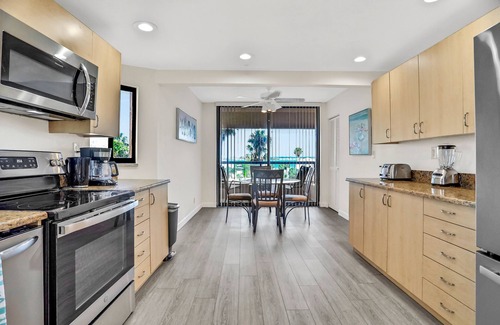 Sand Key Condo | Vibrant, ocean-view condo with hot tub, tennis court, pool, W/D, balcony & grill