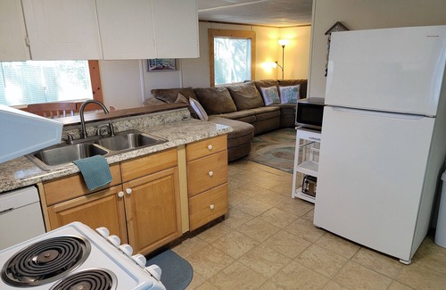Butler Beach Cottage | Wake up to an amazing sunrise from your wood deck with outdoor furniture