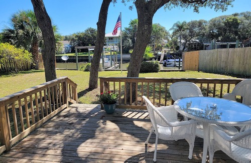 Butler Beach Cottage | Wake up to an amazing sunrise from your wood deck with outdoor furniture
