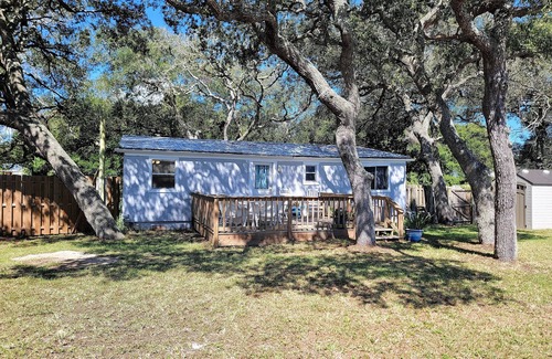 Butler Beach Cottage | Wake up to an amazing sunrise from your wood deck with outdoor furniture