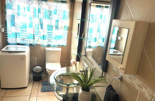 Warner Beach Cottage | Wake up to gorgeous sunrises and sea views upon a wooden balcony.
