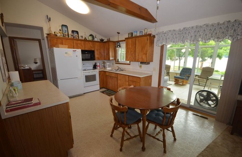Lake Leelanau House | Waterfront home Lake Leelanau. Enclosed porch, WIFI. Canoe, row boat Dog ok.