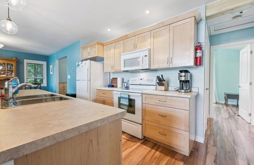 Miller Lake Cottage | Watersedge: 4BR Miller Lake cottage with dock, firepit, decks, spacious interiors, rec room & foosball.
