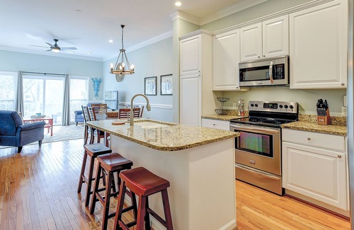 Waters Edge House | Welcoming water view townhome with pool, balcony, deck, & kitchen
