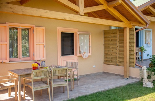 San Brizio Apartment | Wooden house with porch and garden