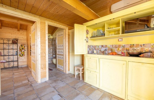 San Brizio Apartment | Wooden house with porch and garden