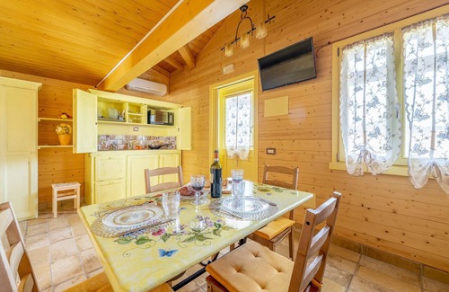 San Brizio Apartment | Wooden house with porch and garden