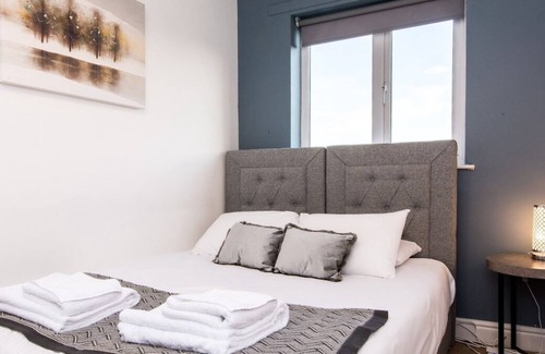 Woodthorpe Apartment | You’ll love putting your feet up in the lounge area, complete with Smart TV and snug sofa space