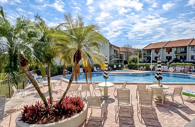 1st-floor condo with bayfront views, pool, hot tub, gym, grills, & balcony